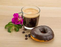 Chocolate donuts on wooden background photo