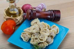 Russian dumplings on the plate and wooden background photo