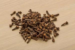 Clove seeds on wooden background photo