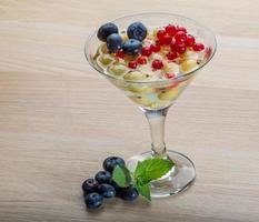 Jelly with berry on wooden background photo