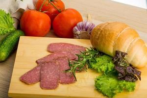 Salami on wooden plate photo