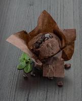 Chocolate muffin on wooden background photo