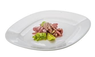 Beef carpaccio on the plate and white background photo