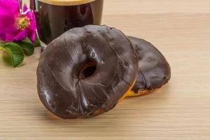 Chocolate donuts on wooden background photo