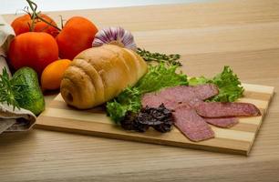 Salami sausages on wooden plate photo