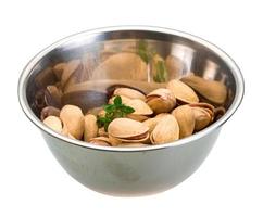 Pistachio in a bowl on white background photo