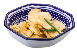 Potato chips in a bowl on white background photo