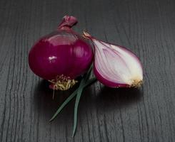 Red onion on wooden background photo