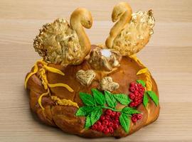 Karavay - Russian traditional bread on wooden background photo