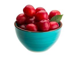 Damson plum in a bowl on white background photo