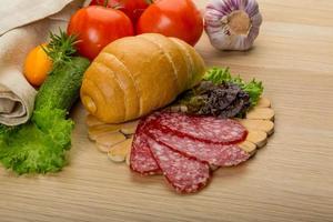 Salami on wooden plate photo