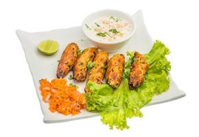 Shish kebab on the plate and white background photo