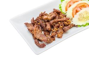 Fried pork thai style on the plate and white background photo