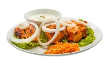 Chicken Tikka on the plate and white background photo