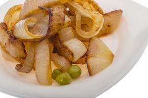 Fried onion on the plate and white background photo