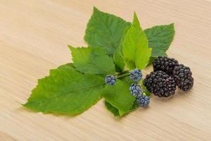 Blackberry on wooden background photo