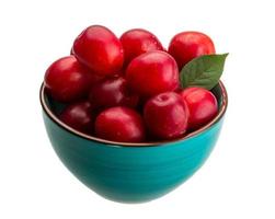 Damson plum in a bowl on white background photo