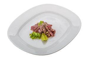 Beef carpaccio on the plate and white background photo