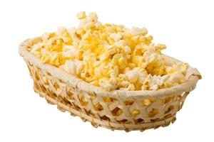 Popcorn in a basket on white background photo