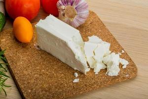 Feta cheese on wooden plate photo