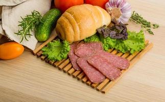 Salami on wooden plate photo