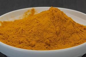 Curcuma powder close up view photo