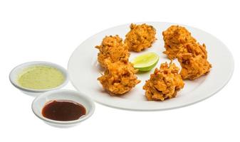 Onion bhajee on the plate and white background photo