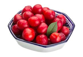 Damson plum in a bowl on white background photo