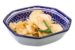 Potato chips in a bowl on white background photo