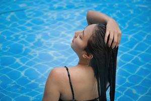 Beautiful southeast asia woman in pool relaxing. photo