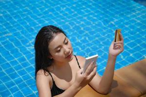 online payment, A teenage girl who swims is using her credit card with her phone to make purchases. online via internet. photo