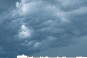 fuertes nubes de lluvia sobre una ciudad, nubes azul oscuro vista espectacular de un cielo foto