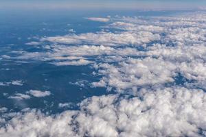 Blue sky background with big white striped clouds. blue sky panorama may use for sky replacement, the view from the plane down to the clouds photo