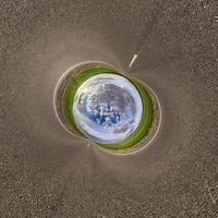Inversion of blue little planet transformation of spherical panorama 360 degrees. Spherical abstract aerial view on road with awesome beautiful clouds. Curvature of space. photo