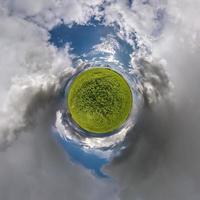 tiny planet transformation of spherical panorama 360 degrees. Spherical abstract aerial view on road with blue sky and awesome beautiful clouds. Curvature of space. photo