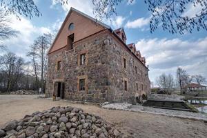 the building of the restored old stone mill in early spring photo