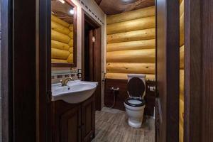 toilet and detail of a corner bidet cabin with wall mount shower attachment photo