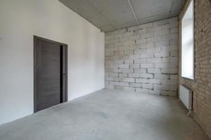 empty loft room with brick wall and repair and without furniture for office photo