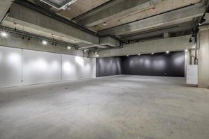 empty interior of large concrete room as warehouse or hangar with spotlights photo