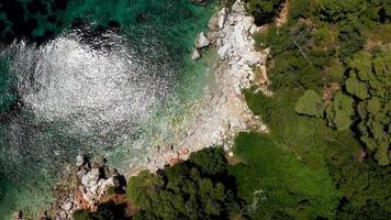 vistas aéreas de drones sobre una costa rocosa, aguas cristalinas del mar Egeo, playas turísticas y mucha vegetación en la isla de skopelos, grecia. una vista típica de muchas islas griegas similares. foto