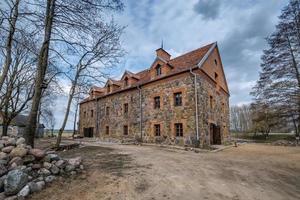 the building of the restored old stone mill in early spring photo