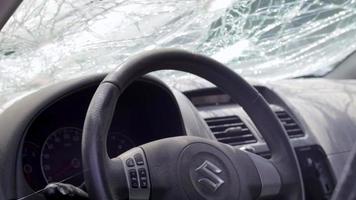 The wreckage of the interior of a modern car after an accident. Car interior after an accident with a cracked and broken windshield. Inside the car after a car accident. Ukraine, Irpin - May 12, 2022. video