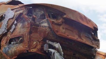 View of burned-out cars after rocket attacks. War of Russia against Ukraine. Civil vehicle after the fire. Cemetery of cars in the city of Irpin. Rusty pile of metal. Iron parts of a burnt car. video