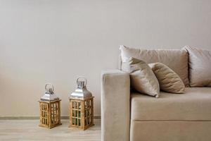 fabric sofa with pillows and lanterns in Interior of modern guestroom in studio apartments photo