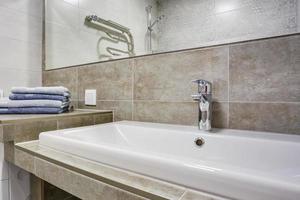 Ceramic Water tap sink with faucet with soap and shampoo dispensers in expensive loft bathroom or kitchen photo