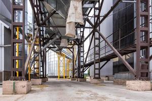 Modern Granary elevator. Silver silos on agro-processing and manufacturing plant for processing drying cleaning and storage of agricultural products, flour, cereals and grain. photo