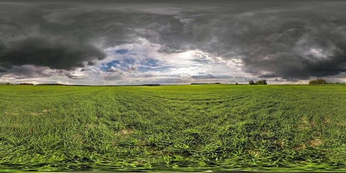 full seamless spherical hdri panorama 360 degrees angle view on among fields in summer day with dark clouds before storm in equirectangular projection photo