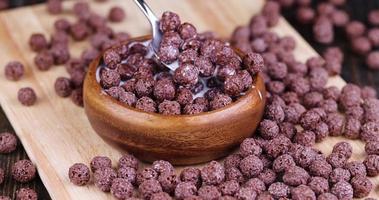 take chocolate balls in milk with a spoon photo