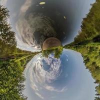 Little planet transformation of spherical panorama 360 degrees. Spherical abstract aerial view in forest. Curvature of space. photo