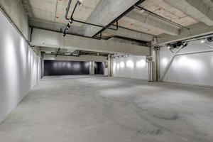 empty interior of large concrete room as warehouse or hangar with spotlights photo